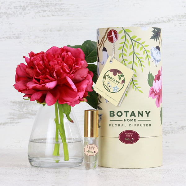 Fake real touch pink peony flower in glass vase with perfume and gift box