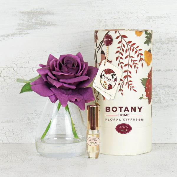 Artificial purple rose arrangement paired with a rose fragrance spray