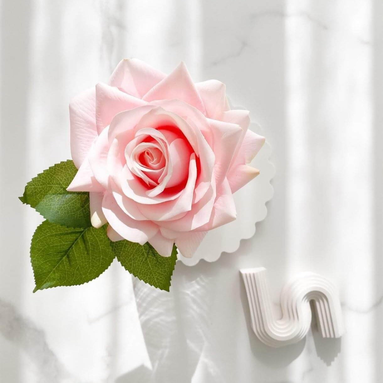 Artificial pink rose arrangement paired with a rose fragrance spray