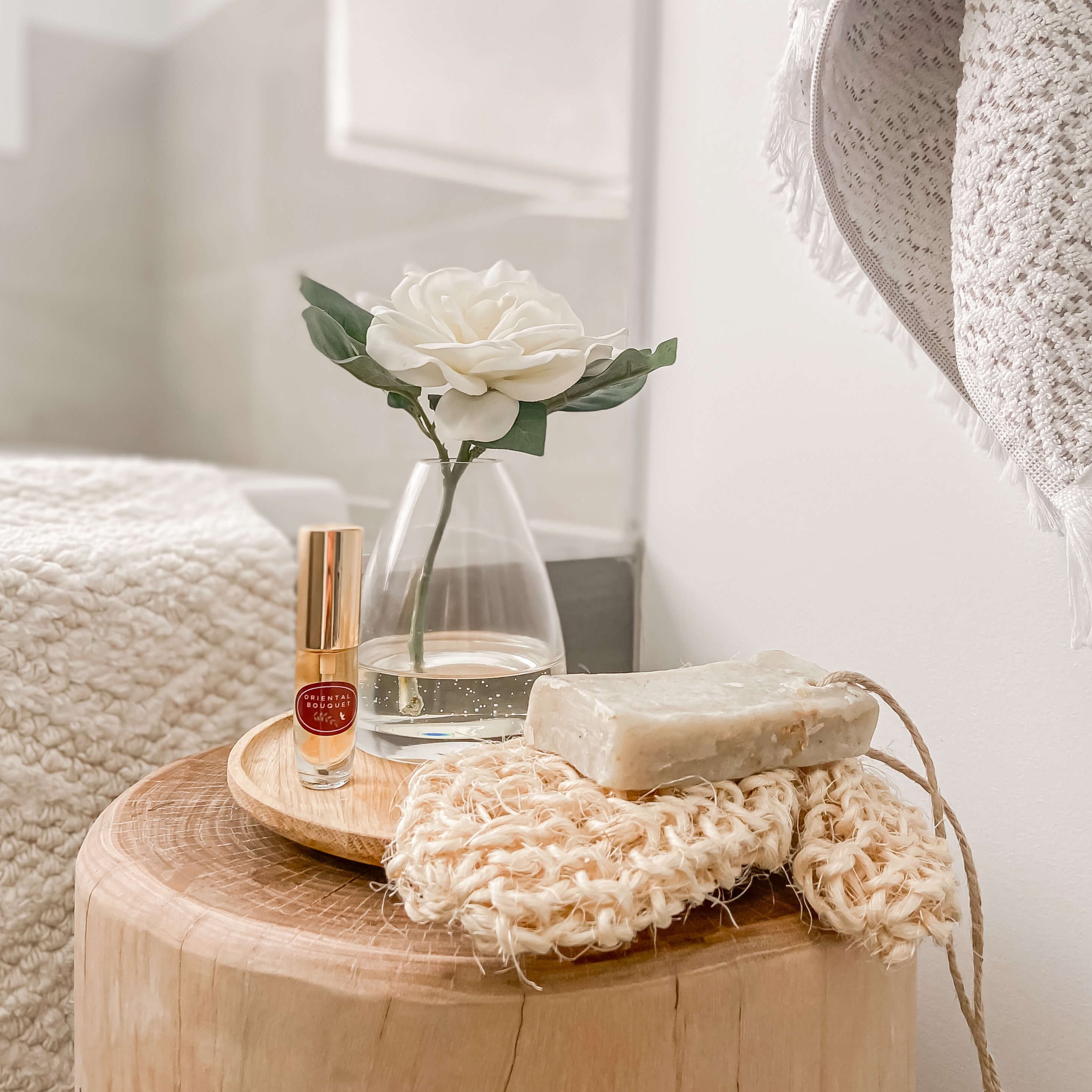 An artificial white Gardenia flower arrangement paired with a floral scent spray