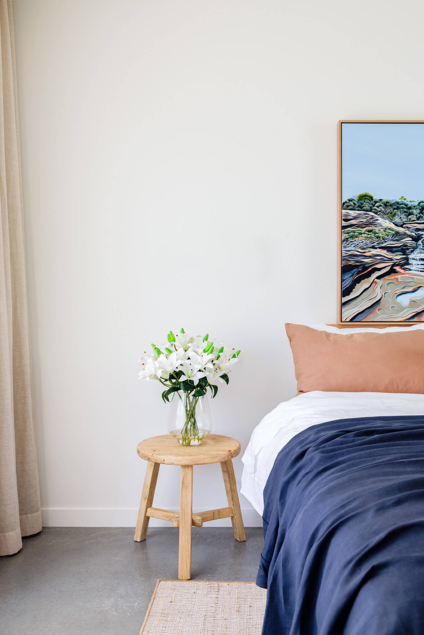 Fake white lily arrangement displayed on a bedside table