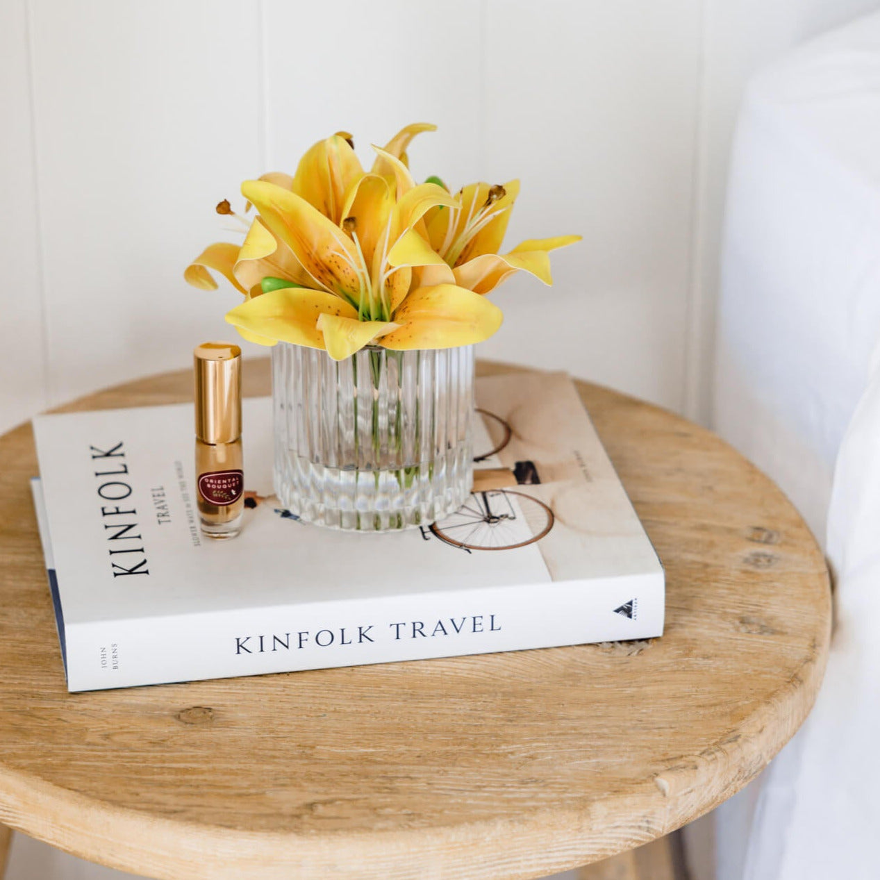 Artificial yellow lily arrangement paired with a floral fragrance spray