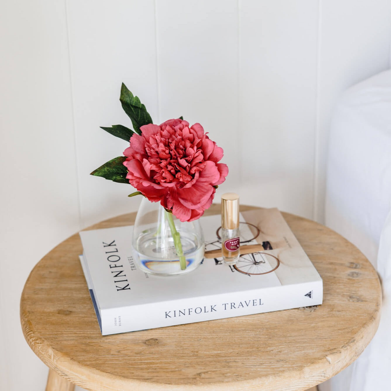 An artificial dark pink Peony flower arrangement paired with a floral scent spray