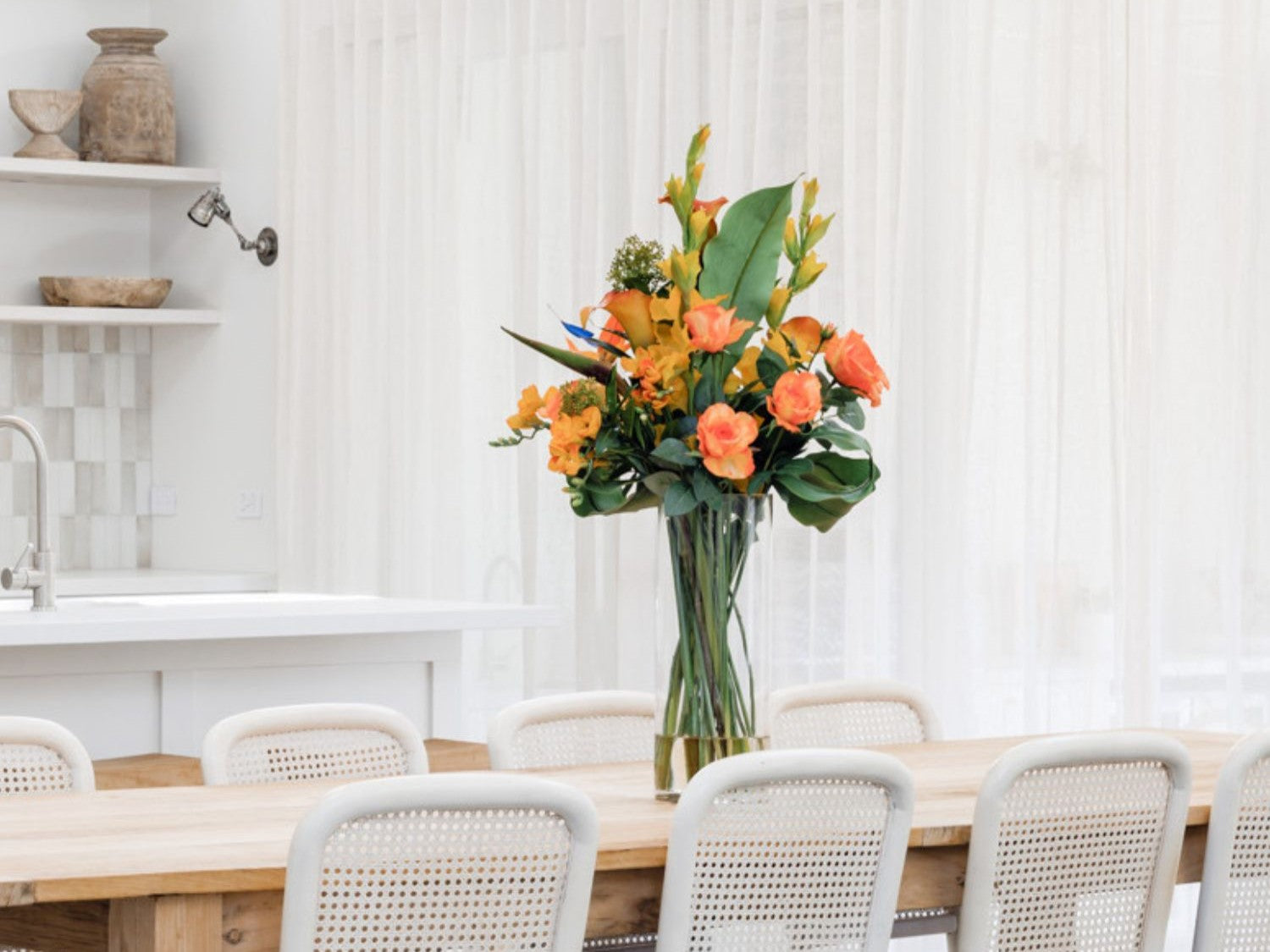 tall artificial flowers in vase