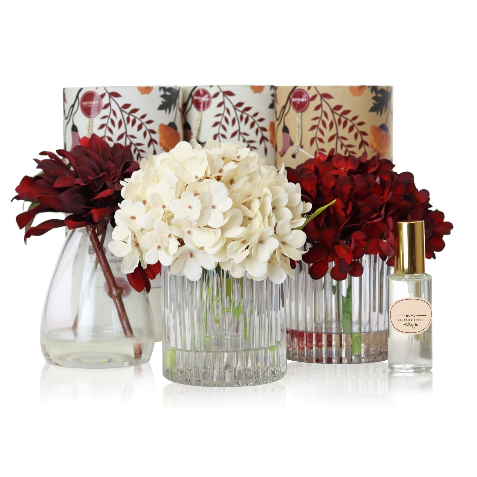 A set of 3 artificial flower arrangements with accompanying floral scent sprays sold as a set of 3