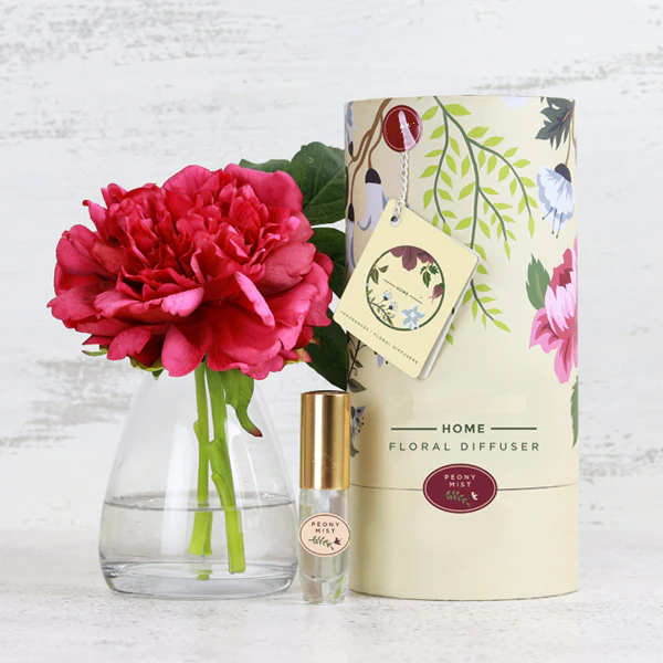 Fake real touch pink peony flower in glass vase with perfume and gift box