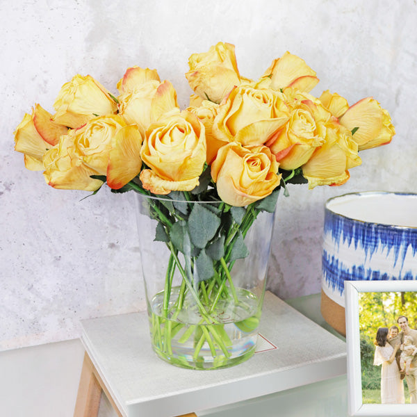 Artificial flower arrangement in glass vase