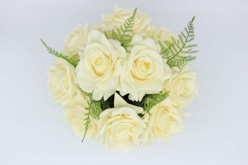 Artificial real touch rose flower arrangement in round glass vase