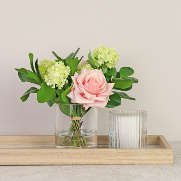 Fake rose flowers with greenery in vase