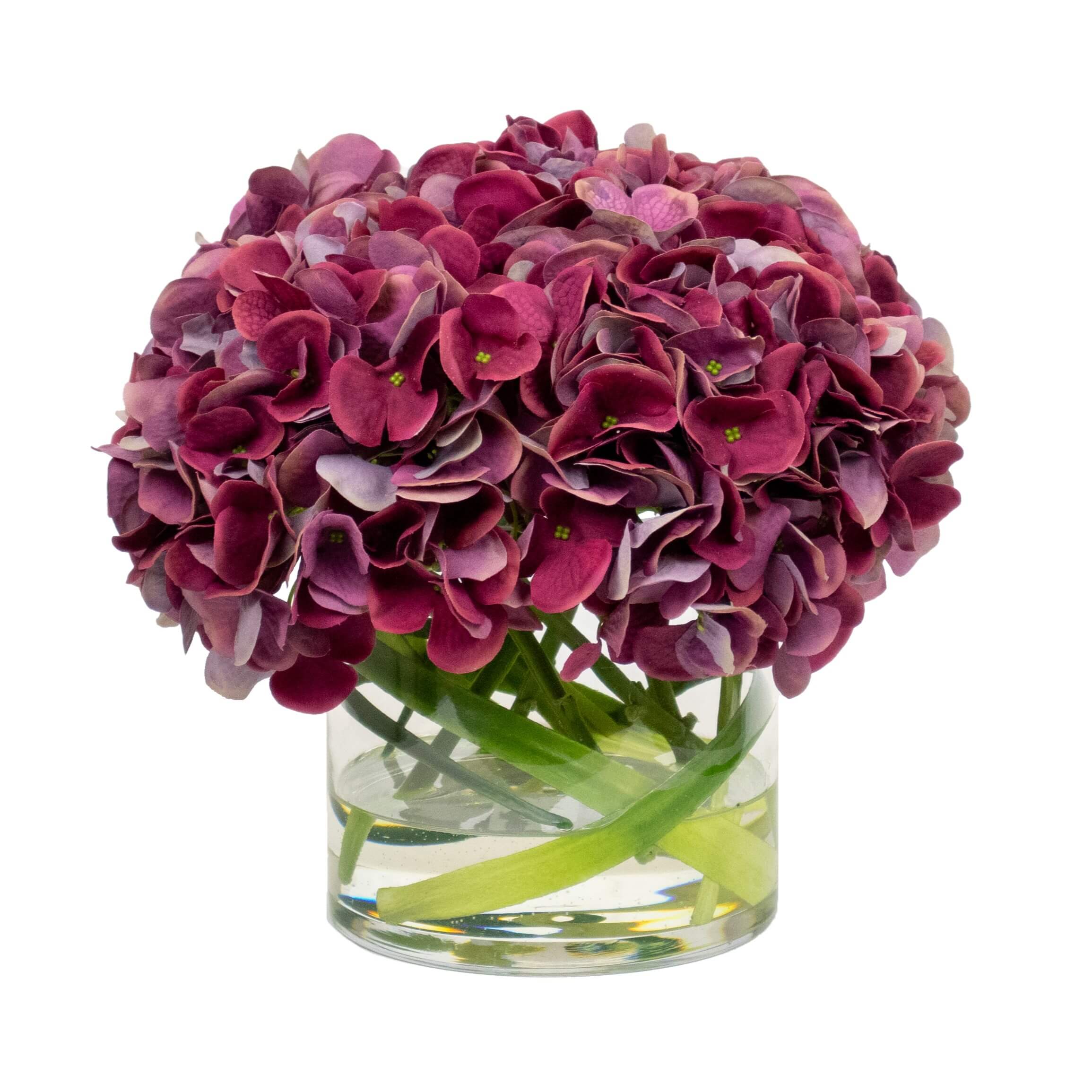 Fake mauve hydrange flowers in glass vase