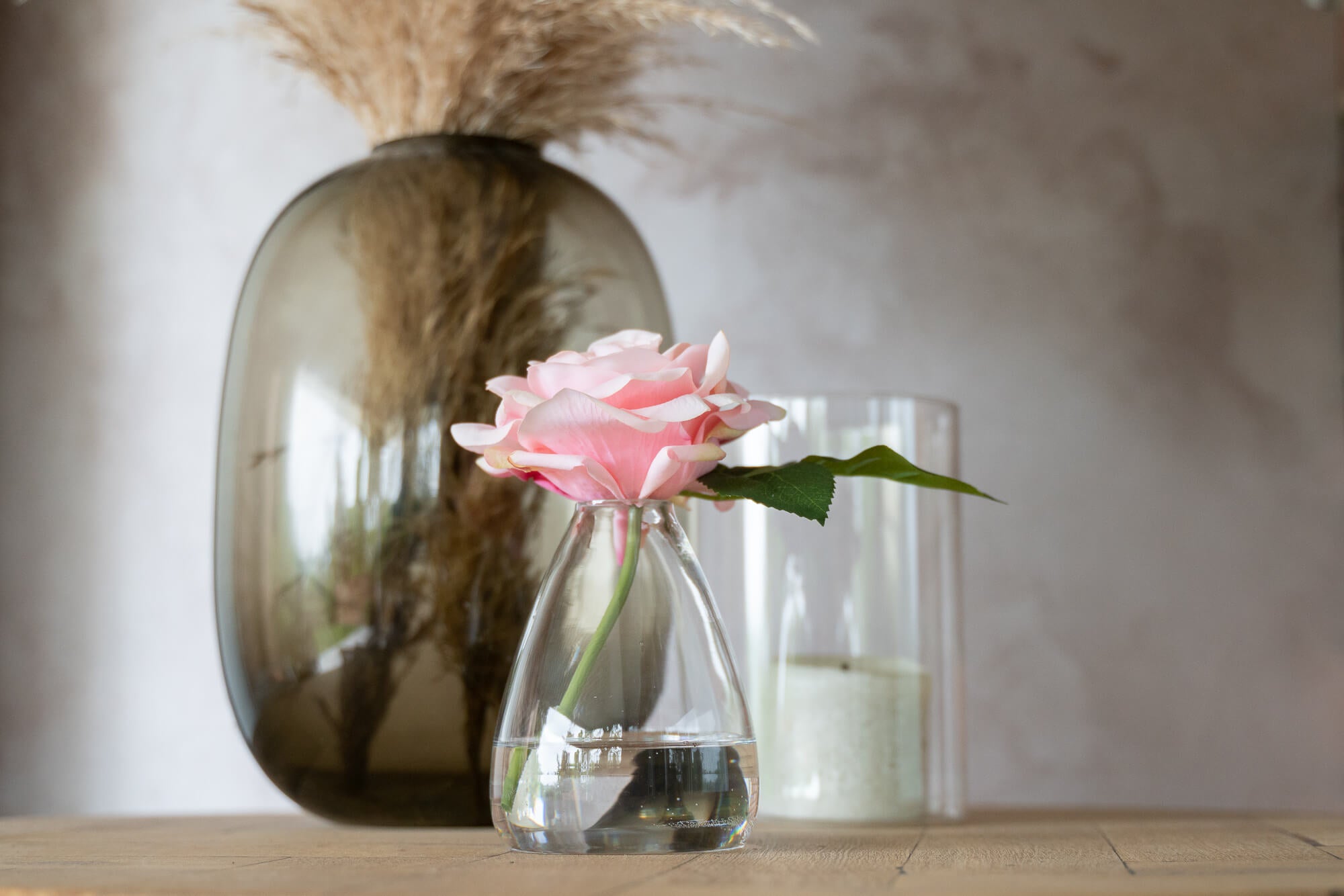 Fake pink rose flower in glass vase