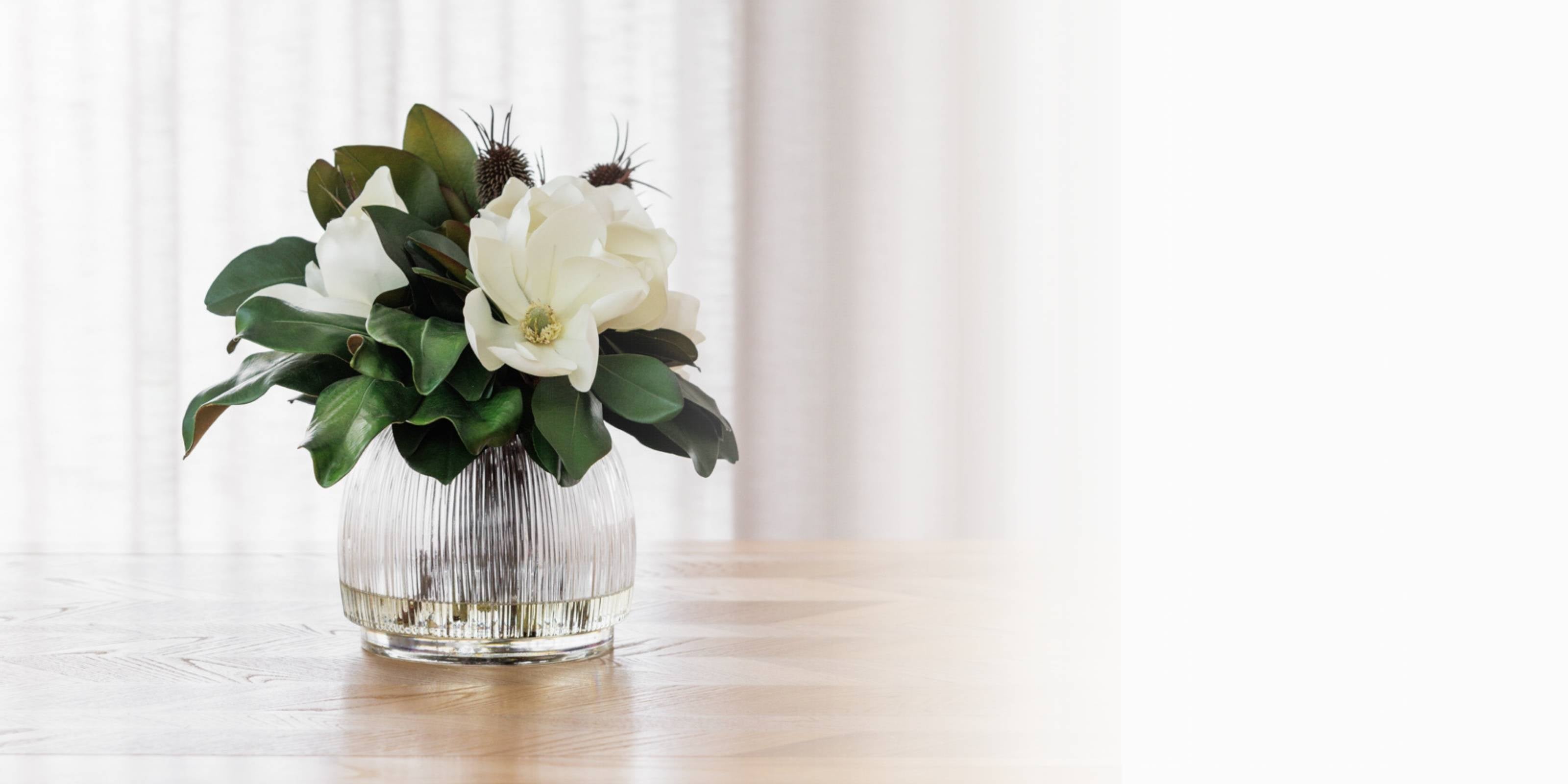 Realistic silk flowers in glass vase