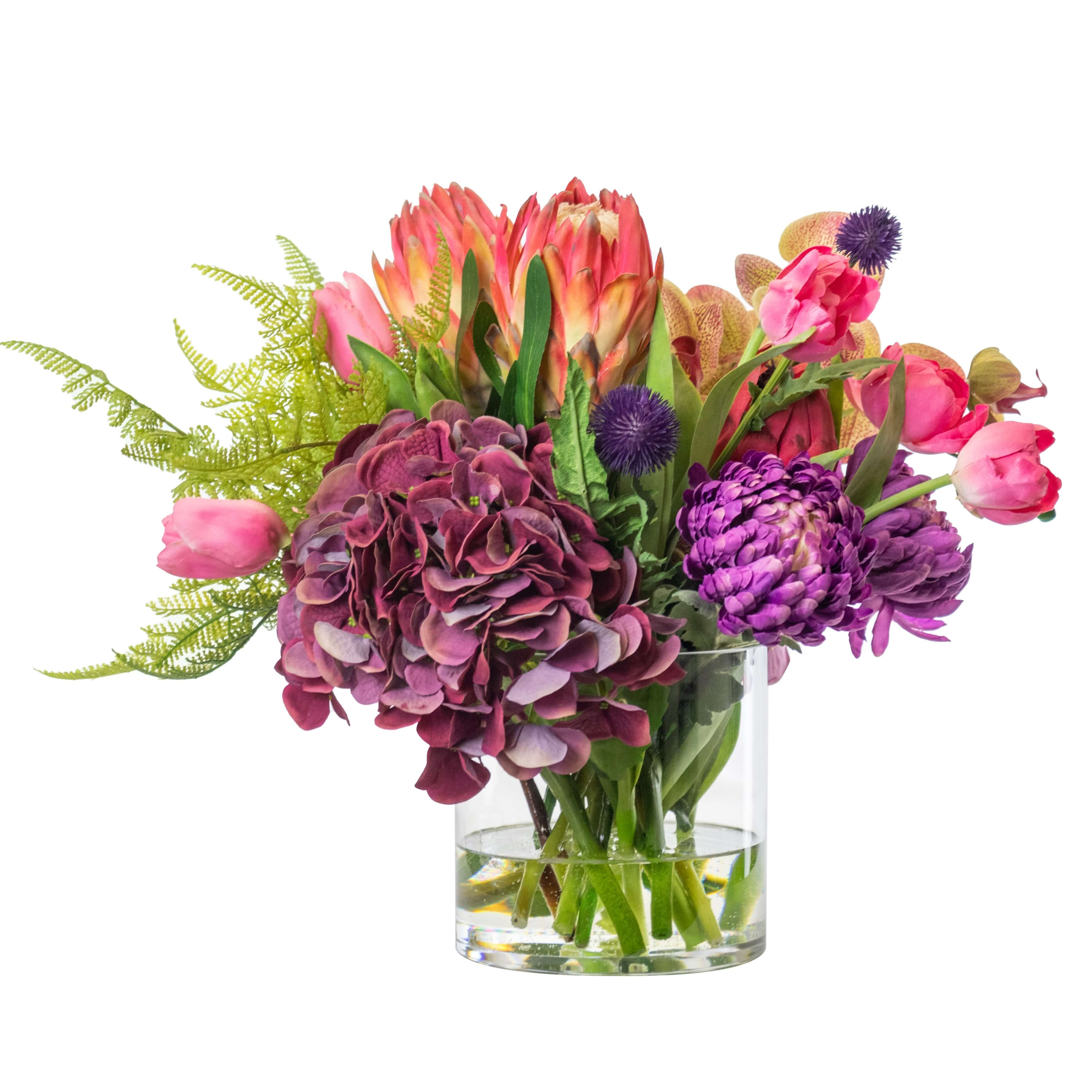 Artificial mixed flower arrangement in glass vase