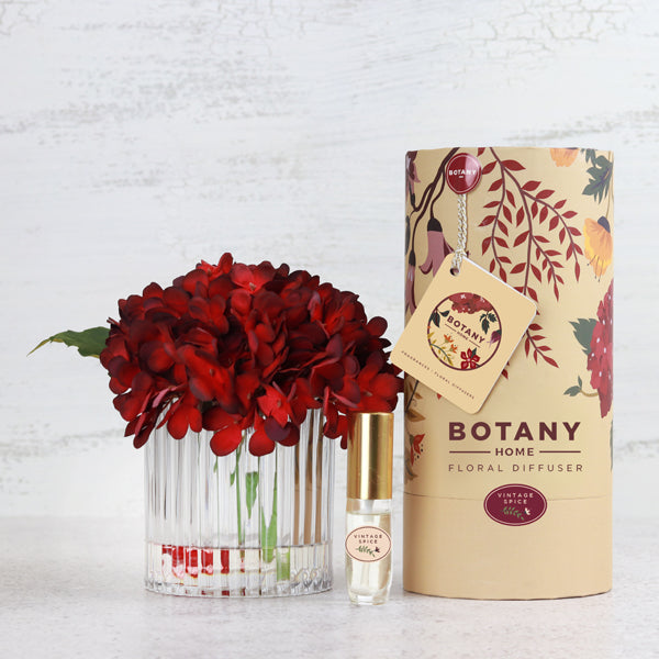 An artificial red hydrangea flower arrangement paired with a floral scent spray