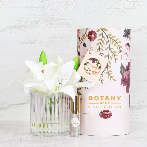 Artificial white lily arrangement paired with a floral fragrance spray
