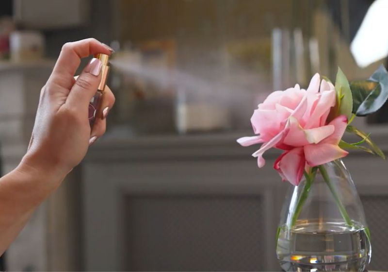 Fake flower being sprayed with perfume