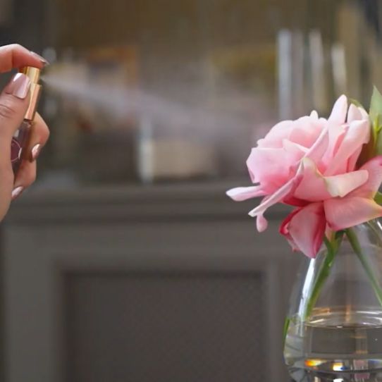 Fake flower being sprayed with perfume