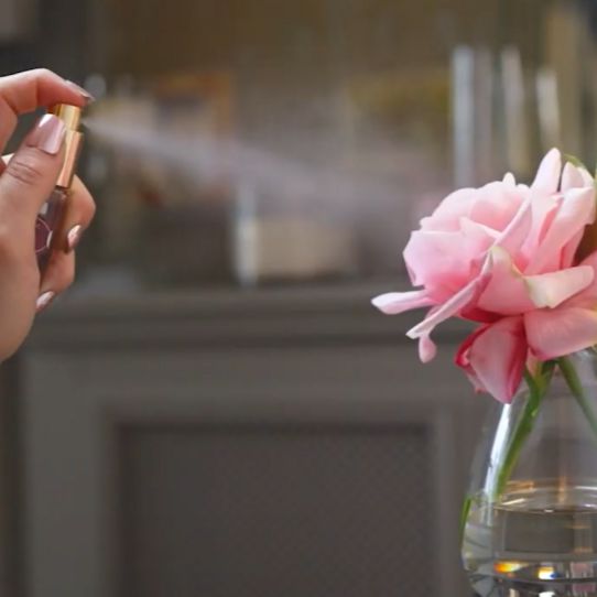 Fake flower being sprayed with perfume