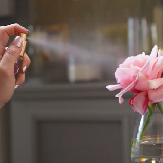 Fake flower being sprayed with perfume