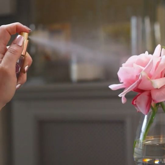 Fake flower being sprayed with perfume