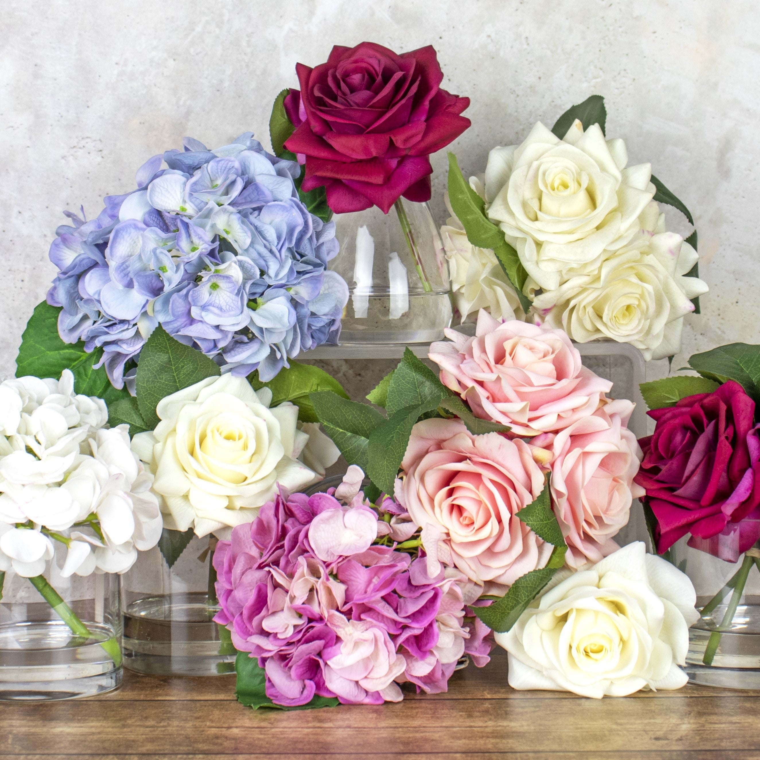 Grouped picture of various artificial flowers in glass vases