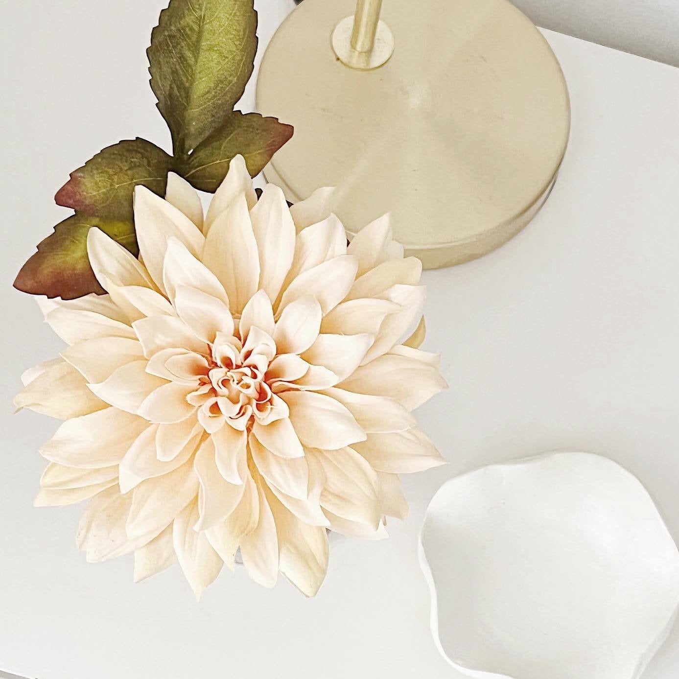 Dahlia flower in vase with perfume for home fragrance