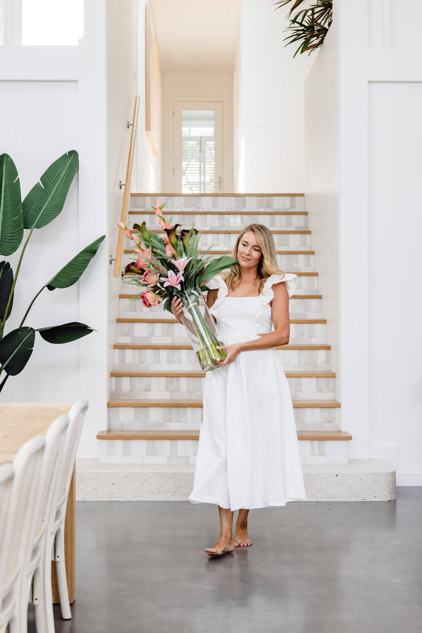 Tall artificial flower bouquet in glass vase