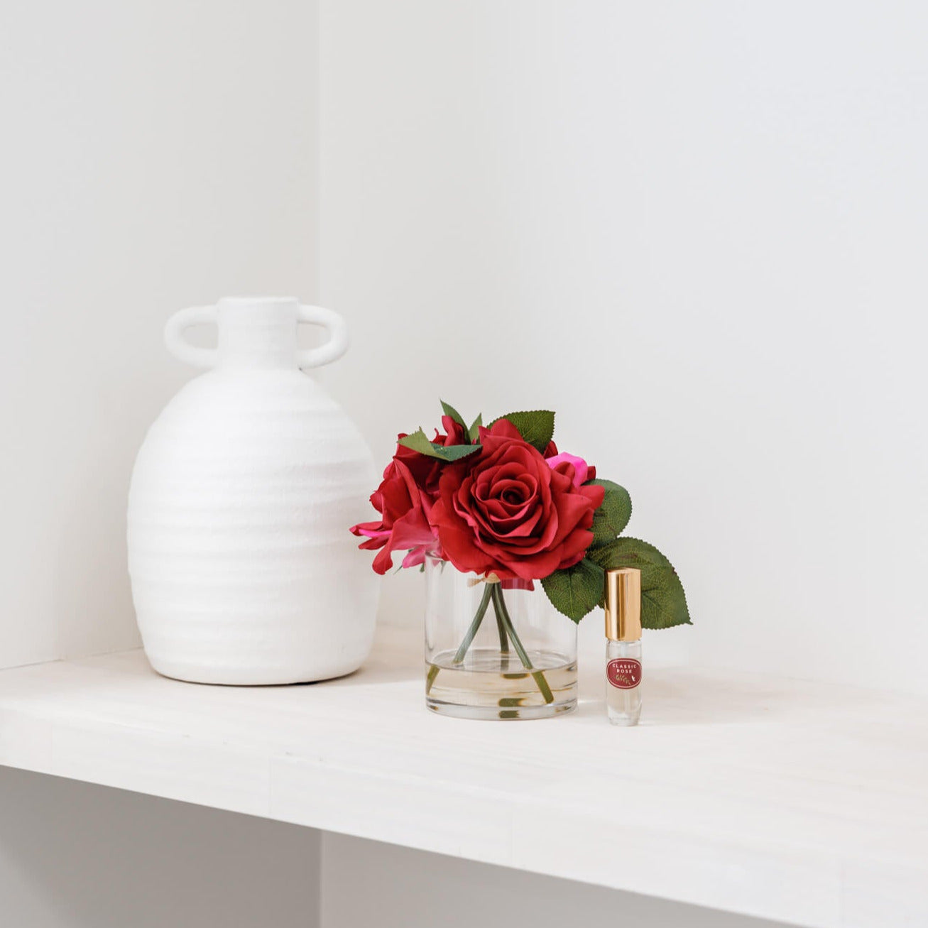 Fake roses in vase with perfume