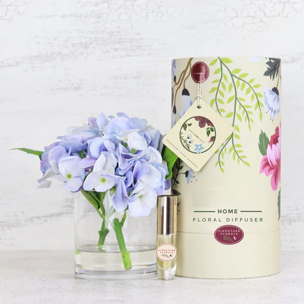 Fake blue hydrangea flower arrangement with floral perfume spray