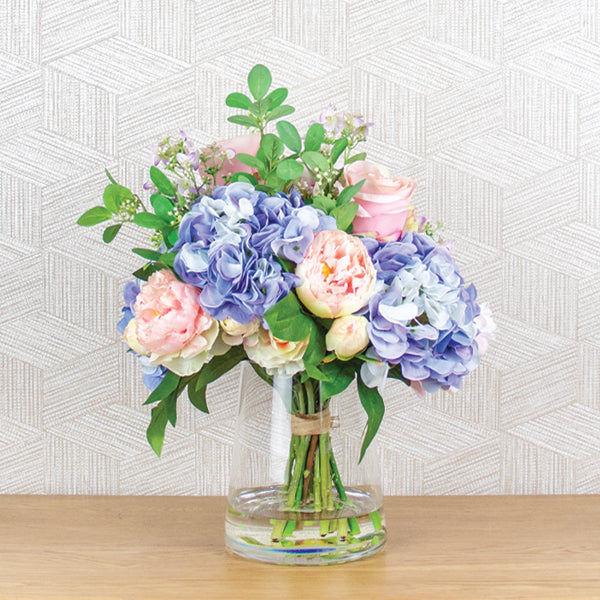 plastic hydrangea and rose flower arrangement in glass vase