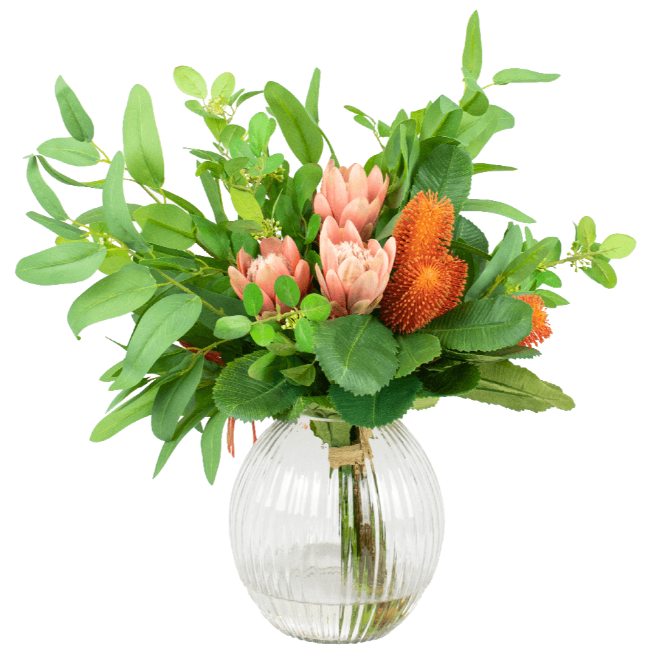 artificial native flower arrangement in ribbed glass vase