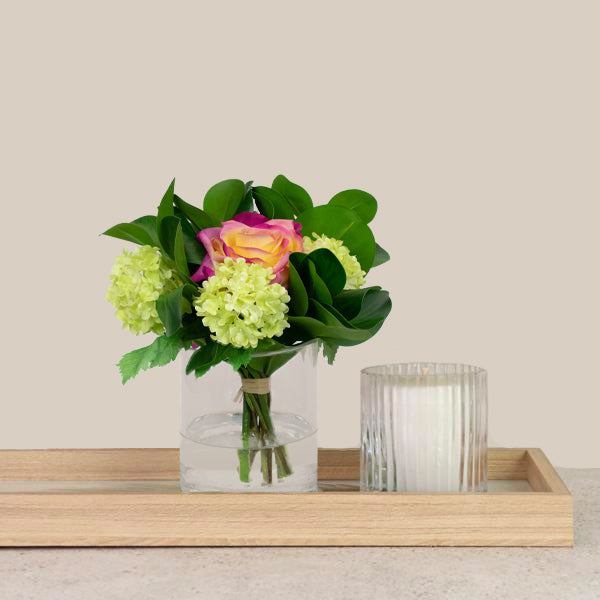 Fake rose flowers with greenery in vase