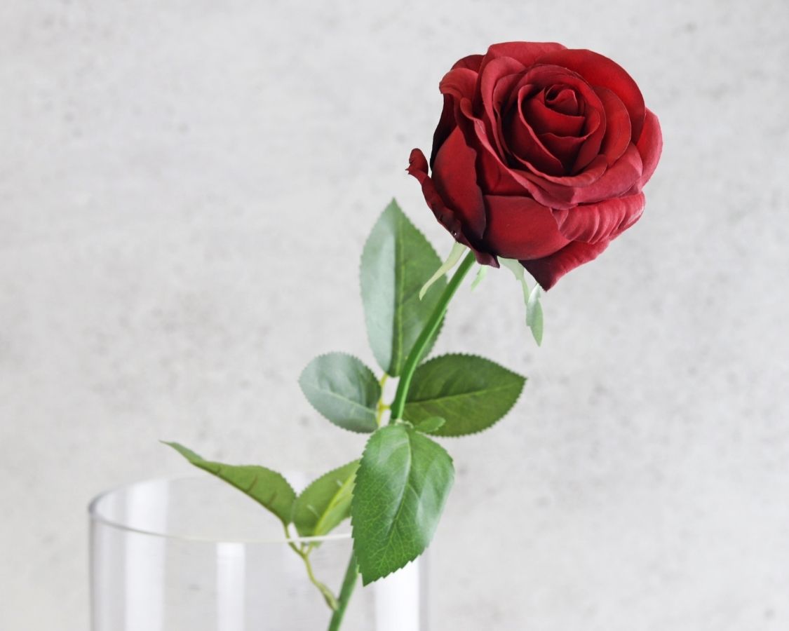 artificial red rose flower with stem in vase