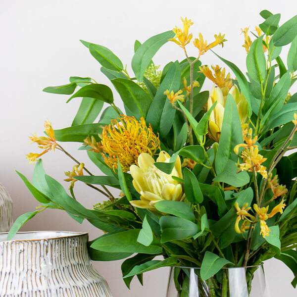 silk flowers in a glass vase