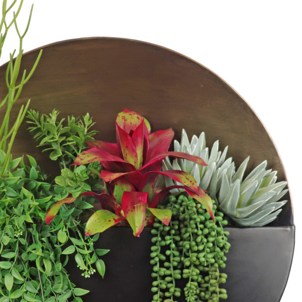 Artificial greenery in wall hanger