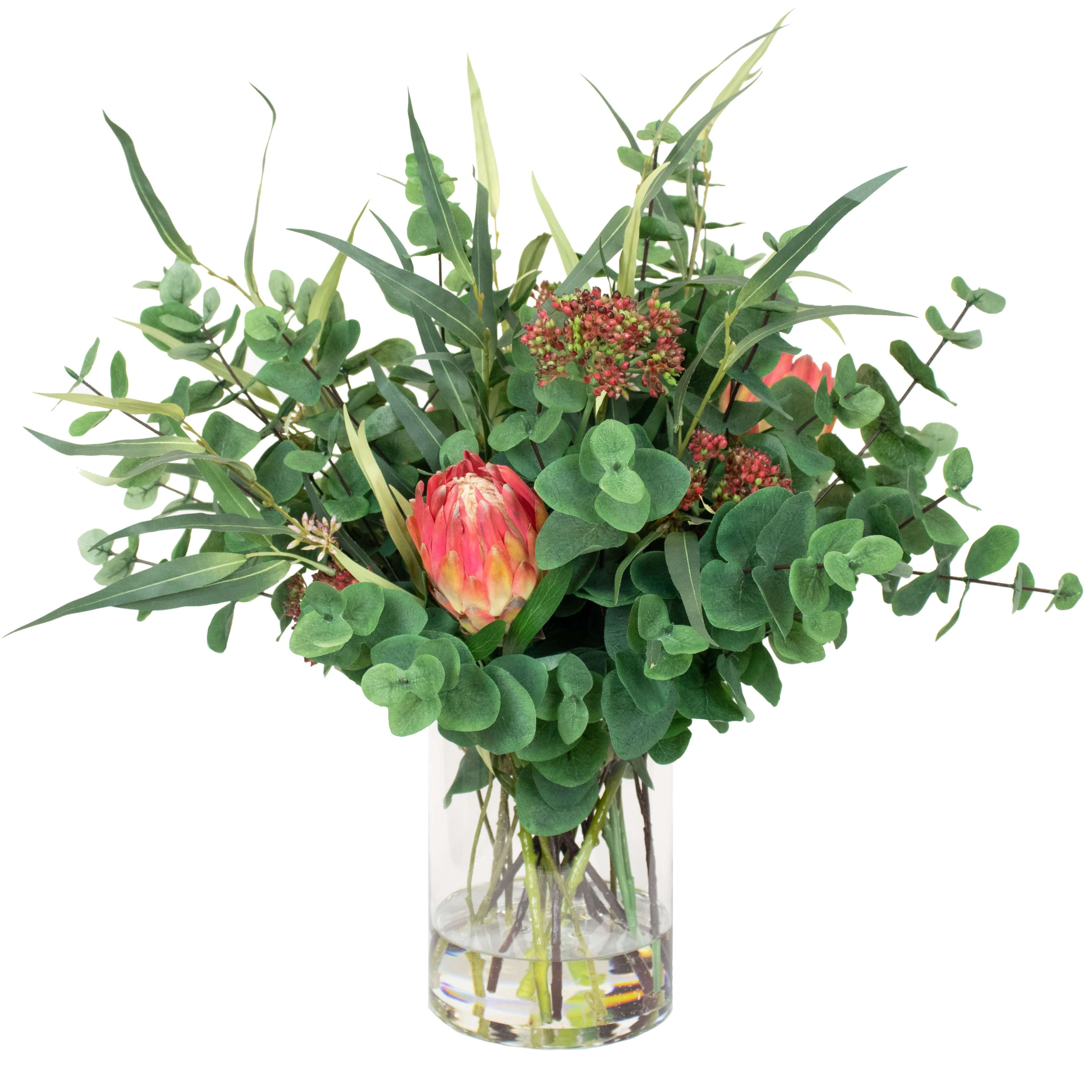 Artificial silk flowers in glass vase