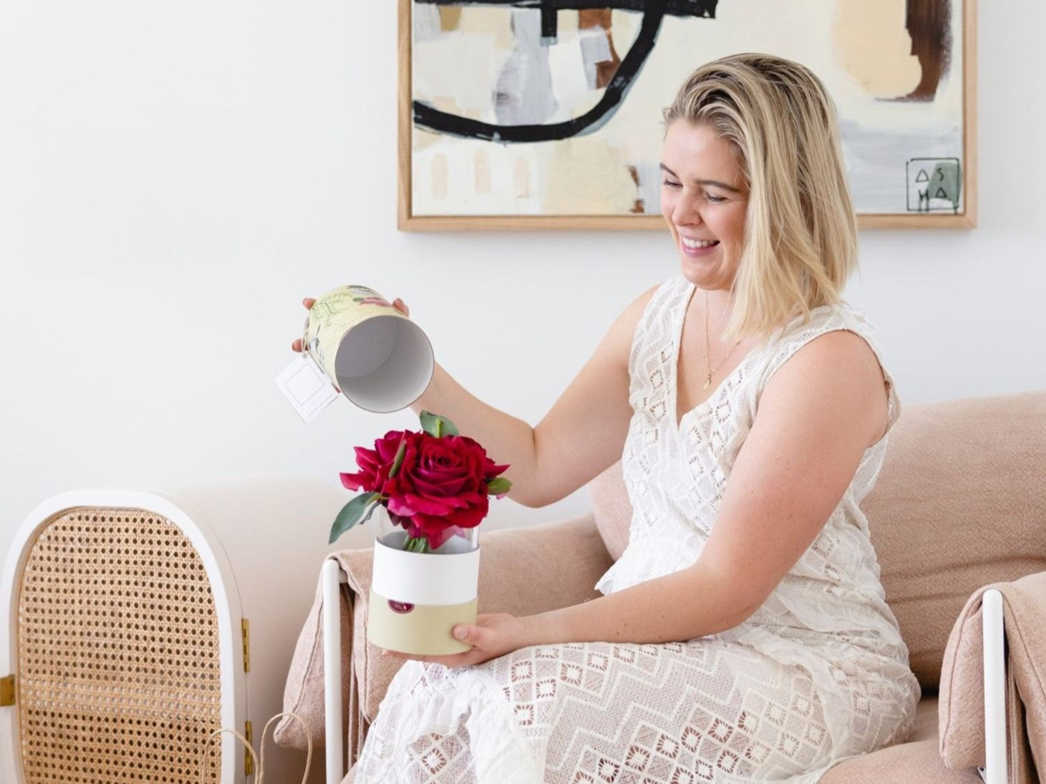 woman opening floral gift with fagrance spray