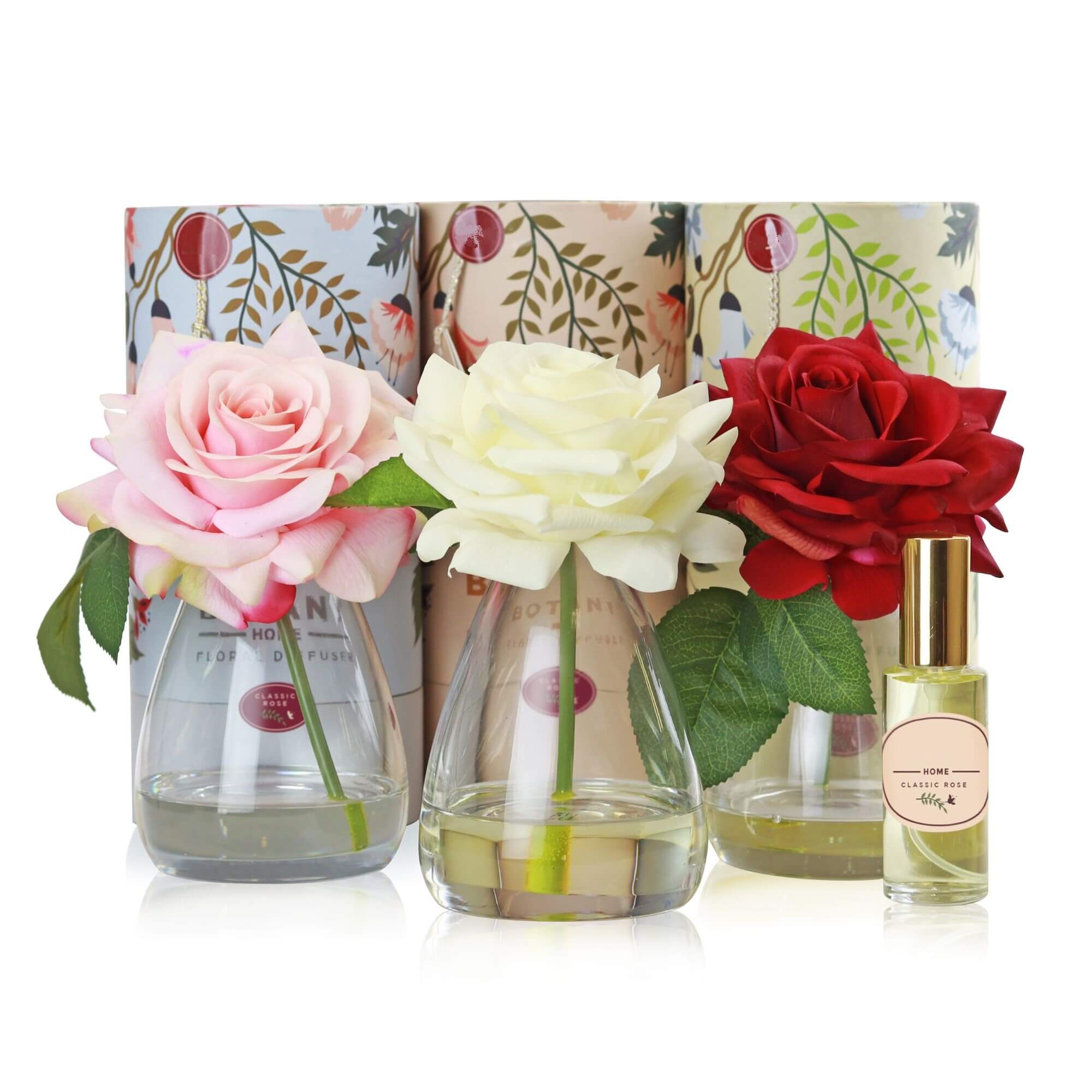 A set of 3 artificial rose arrangements with accompanying floral scent sprays sold as a set of 3