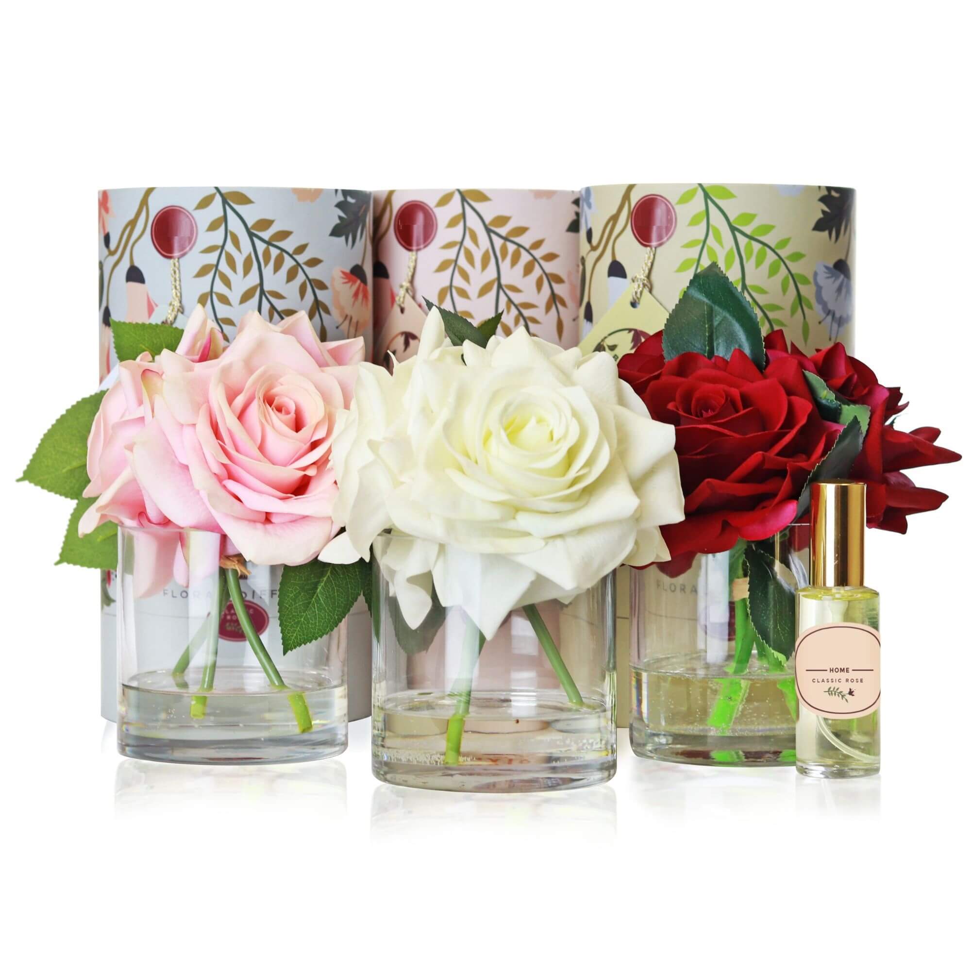 A set of 3 artificial triple rose arrangements with accompanying floral scent sprays sold as a set of 3