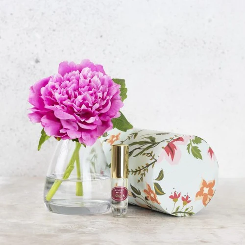 Silk peony flower in vase with floral fragrance spray