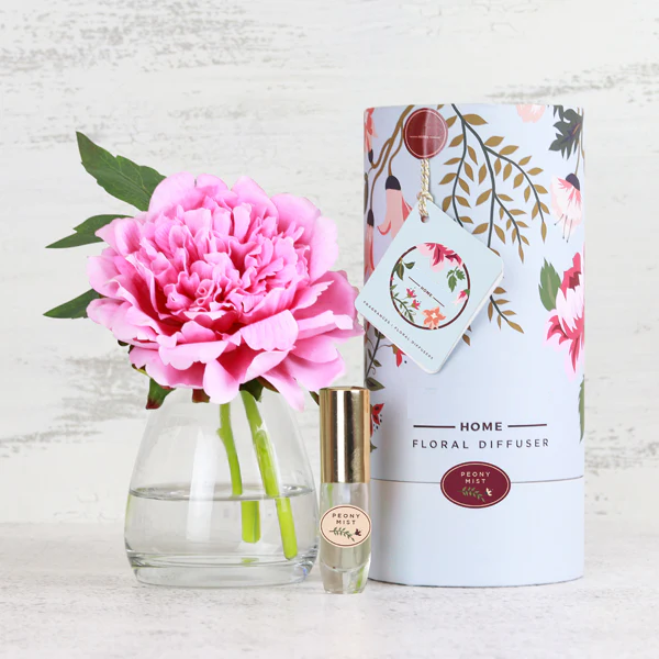 Fake pink peony flower stem in glass vase and gift box packaging