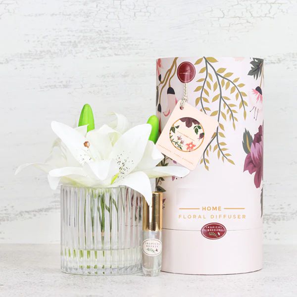 Artificial white lily arrangement paired with a floral fragrance spray