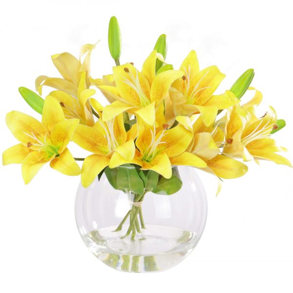 Artificial yellow lily arrangement set in a glass vase