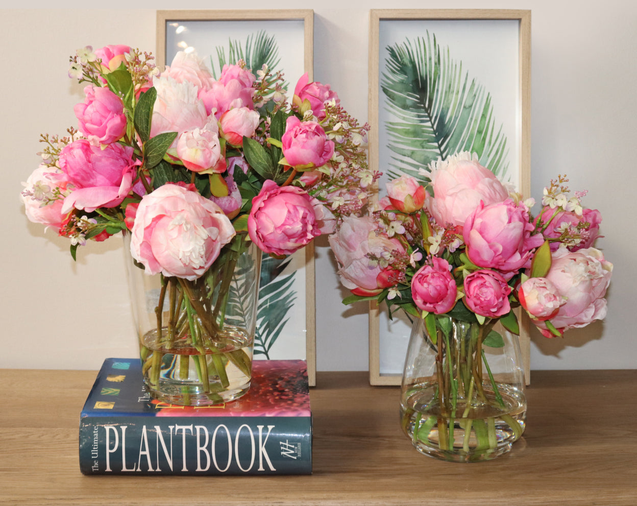 Faux pink peony arrangements positioned together on a table