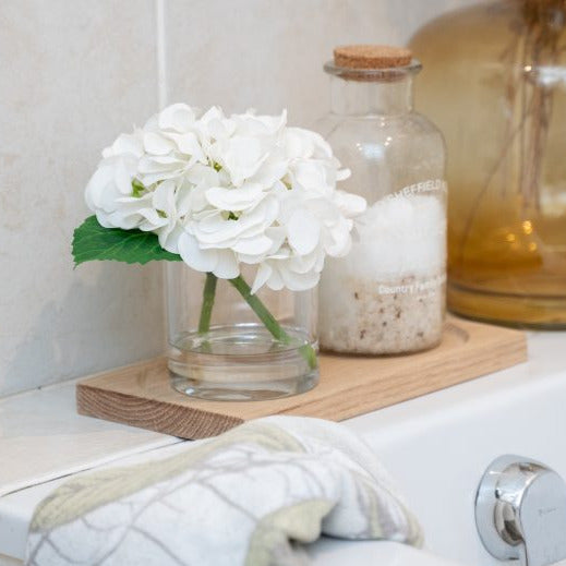 Fake flowers in vase with floral fragrance spray