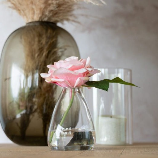 Pink roses artificial in glass vase with floral perfume