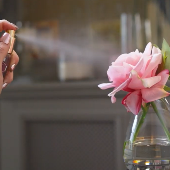 Fake flower being sprayed with perfume