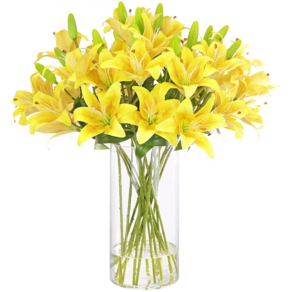 Artificial yellow lily arrangement set in a tall glass vase