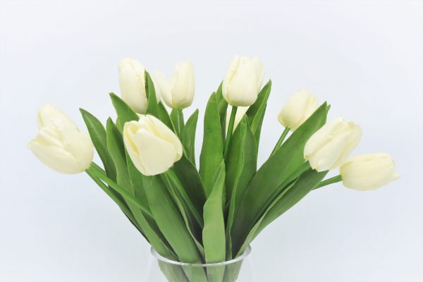 artificial white tulip arrangement in glass vase