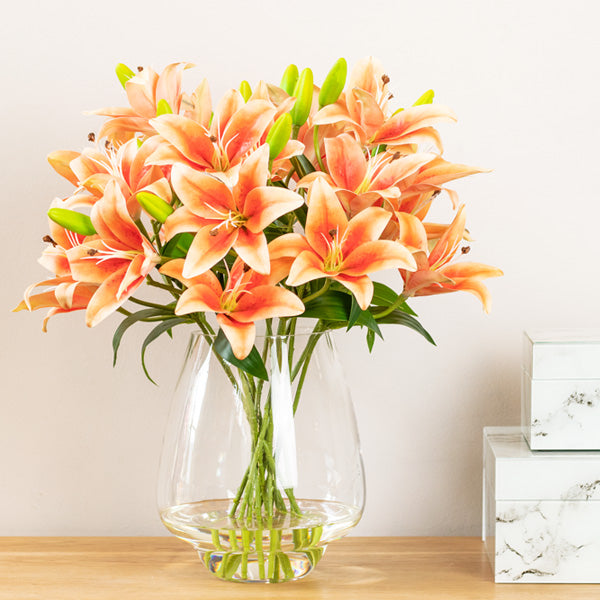 Faux orange lily arrangement on side table